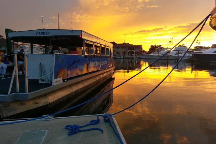 view of boat in dock at sunset