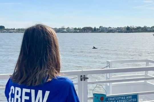 a man standing next to a body of water