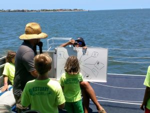 a group of people standing next to a body of water