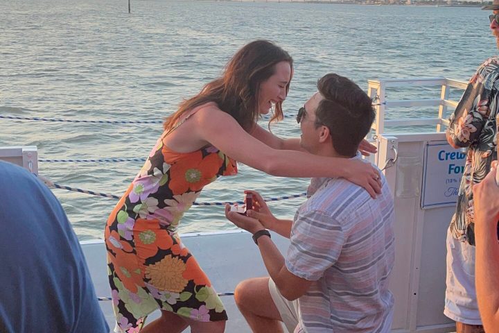a group of people standing next to a body of water