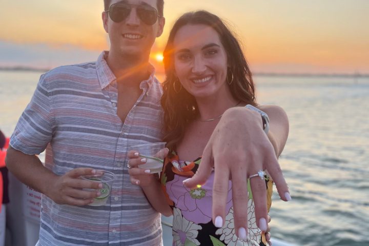 a person standing next to a body of water