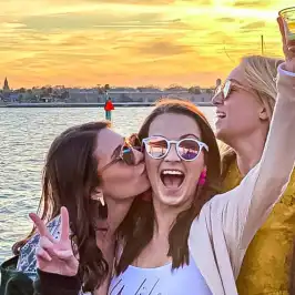a woman standing next to a body of water