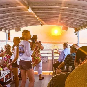 a group of people sitting at a table with a teddy bear