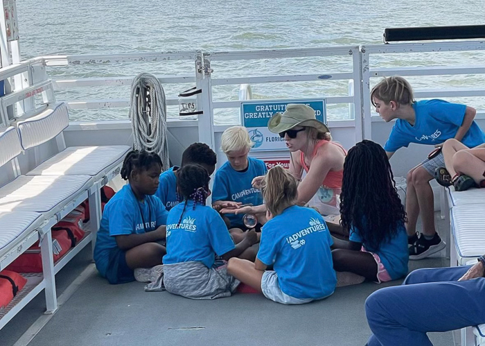 a group of people sitting at a dock