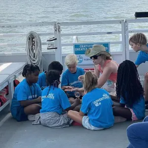 a group of people sitting at a dock