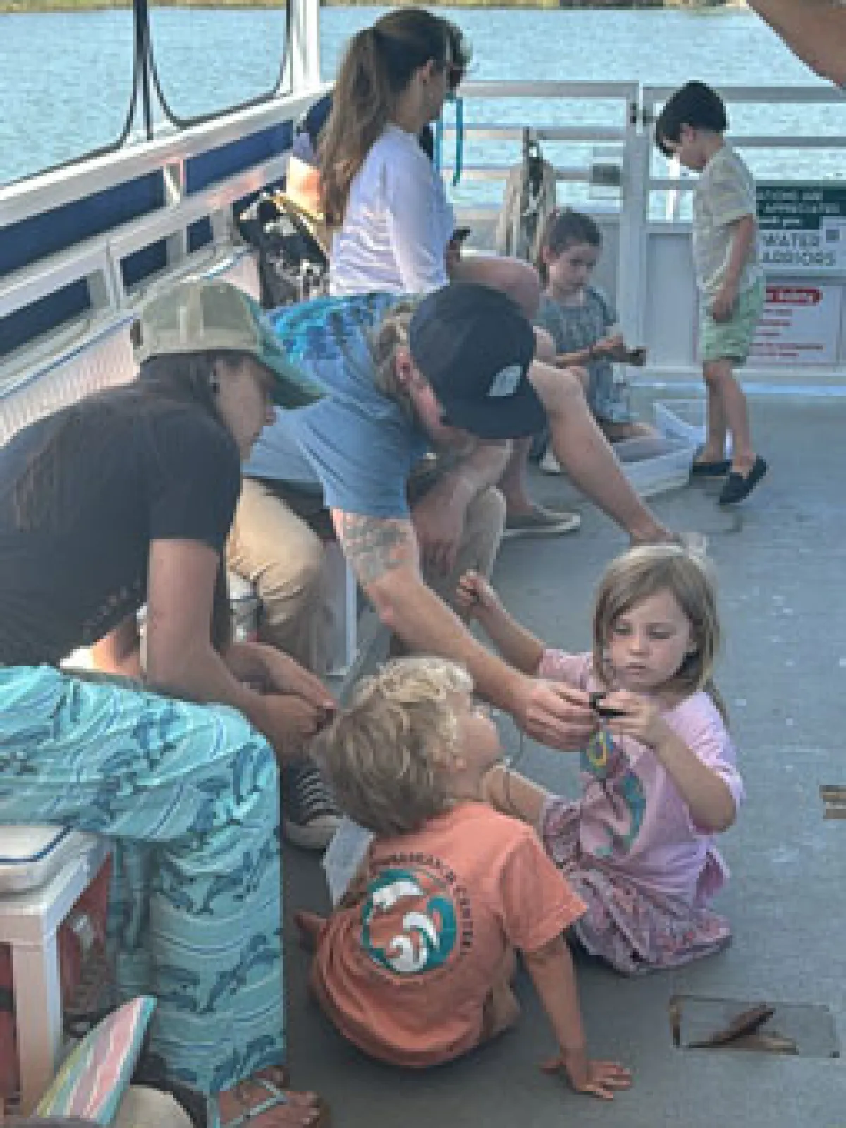 a group of people sitting at a dock