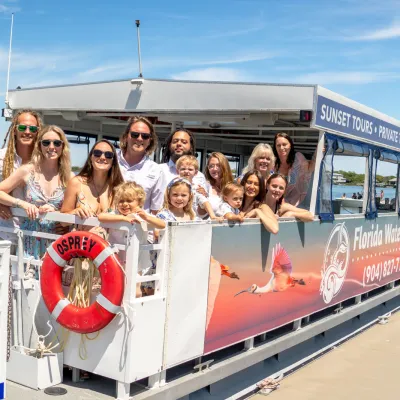 a group of people on a boat posing for the camera