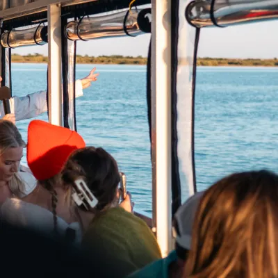 a group of people sitting in front of a body of water