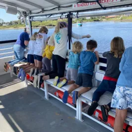 a group of people sitting at a train station