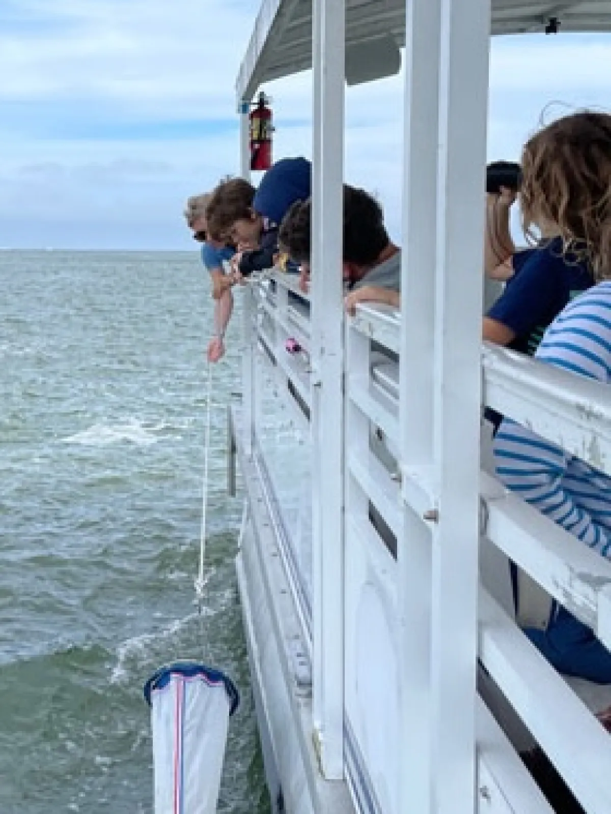 a group of people standing next to a body of water