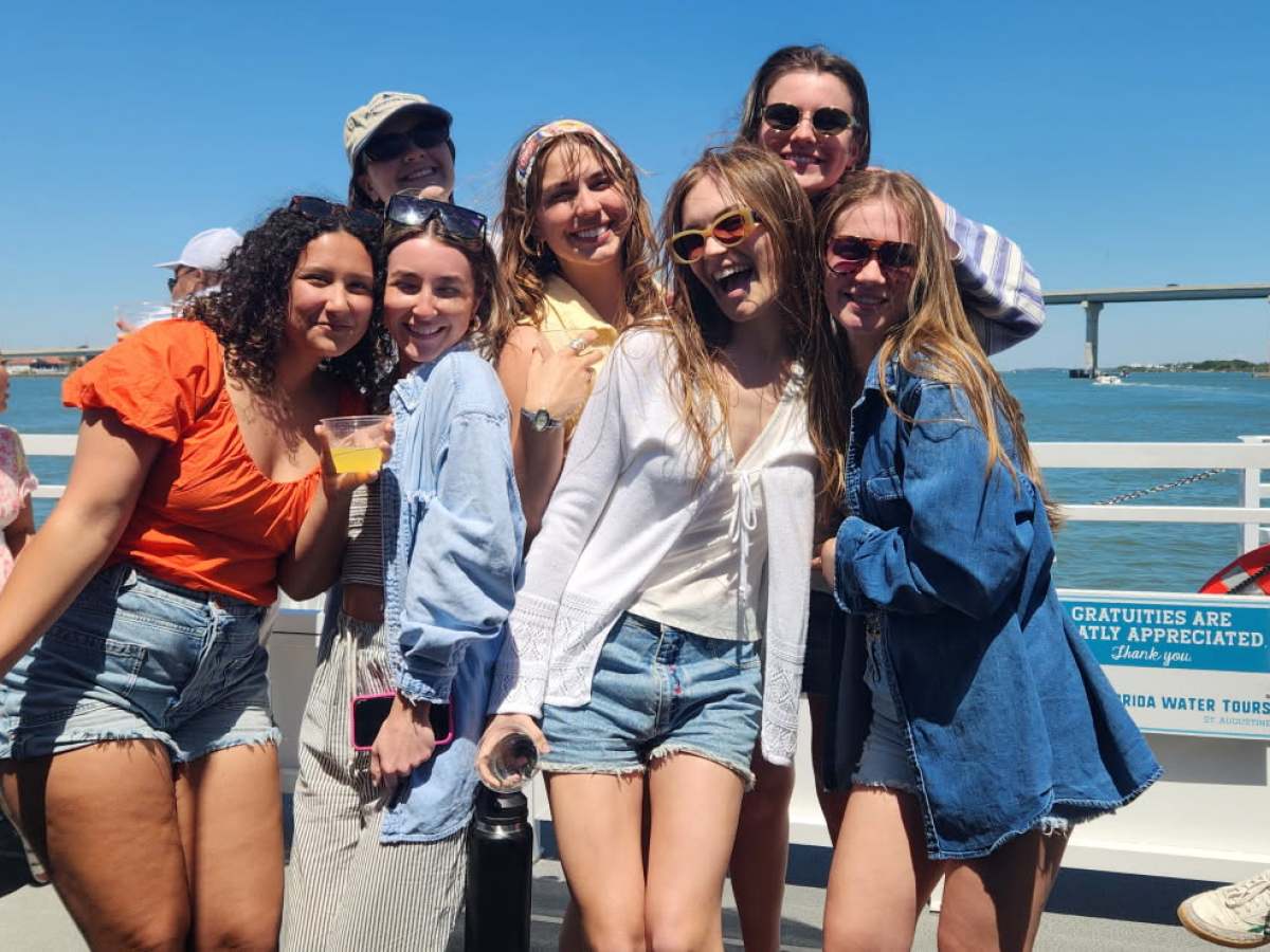 a group of people sitting at a dock