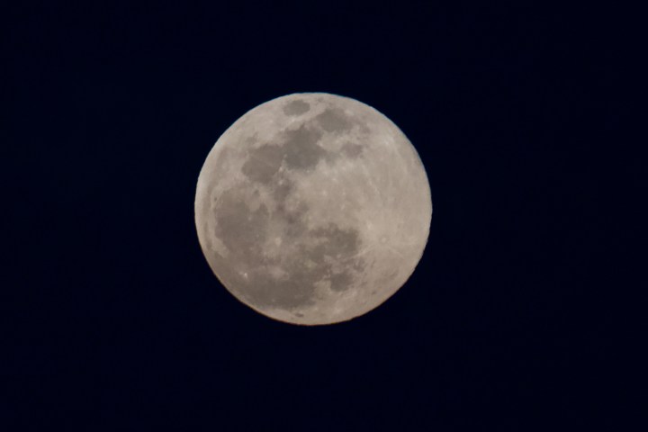 Full moon in a clear night sky with visible craters.