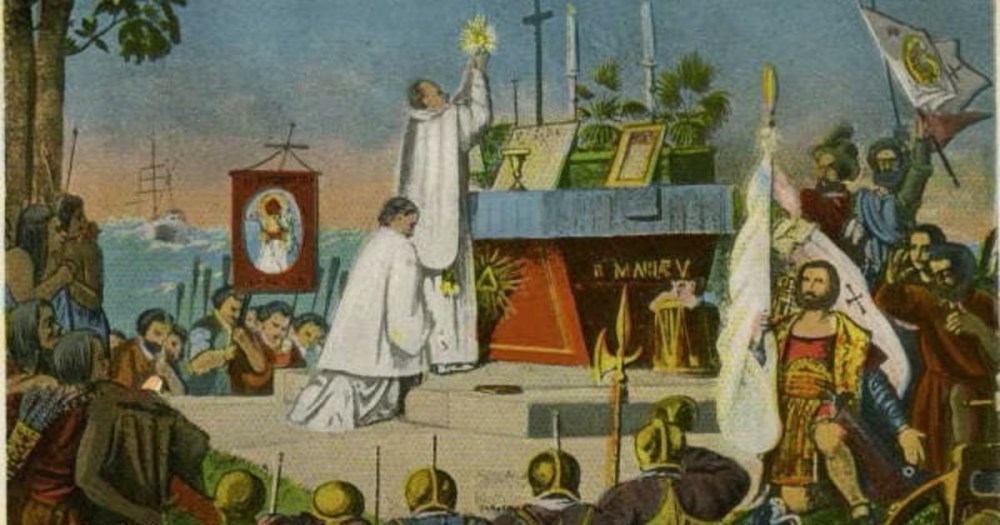 Priests conducting a religious ceremony outdoors with onlookers and a ship in the background.